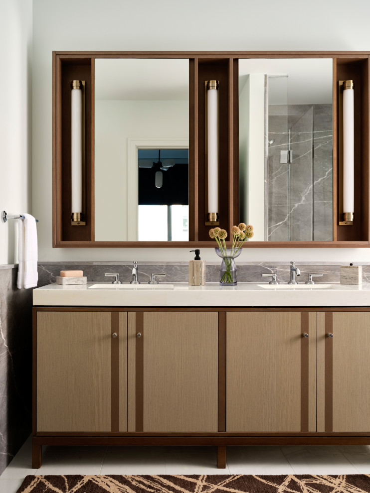 Inspiration for a mid-sized modern master gray tile and ceramic tile double-sink, ceramic tile and white floor drop-in bathtub remodel in Boston with flat-panel cabinets, light wood cabinets, an undermount sink, marble countertops, white countertops, a freestanding vanity, a one-piece toilet, white walls and a niche