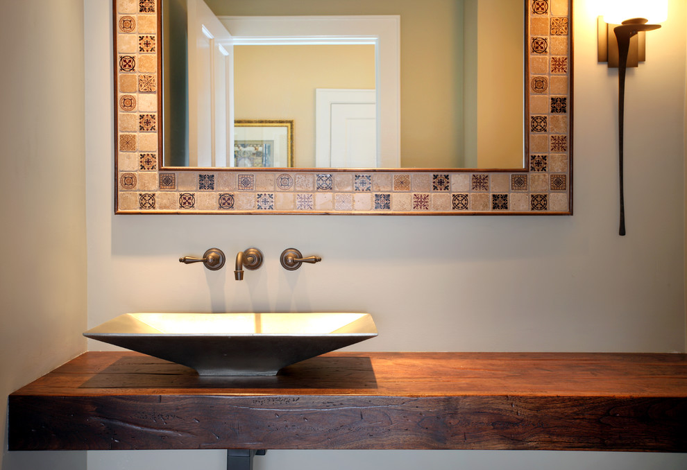 Mid-sized contemporary powder room in Chicago with a vessel sink, wood benchtops, beige walls and brown benchtops.