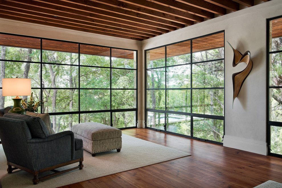 This is an example of a mediterranean master bedroom in Austin with white walls and medium hardwood floors.