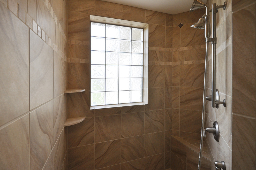 Inspiration for a large traditional master bathroom in Milwaukee with a corner shower, beige tile and ceramic tile.
