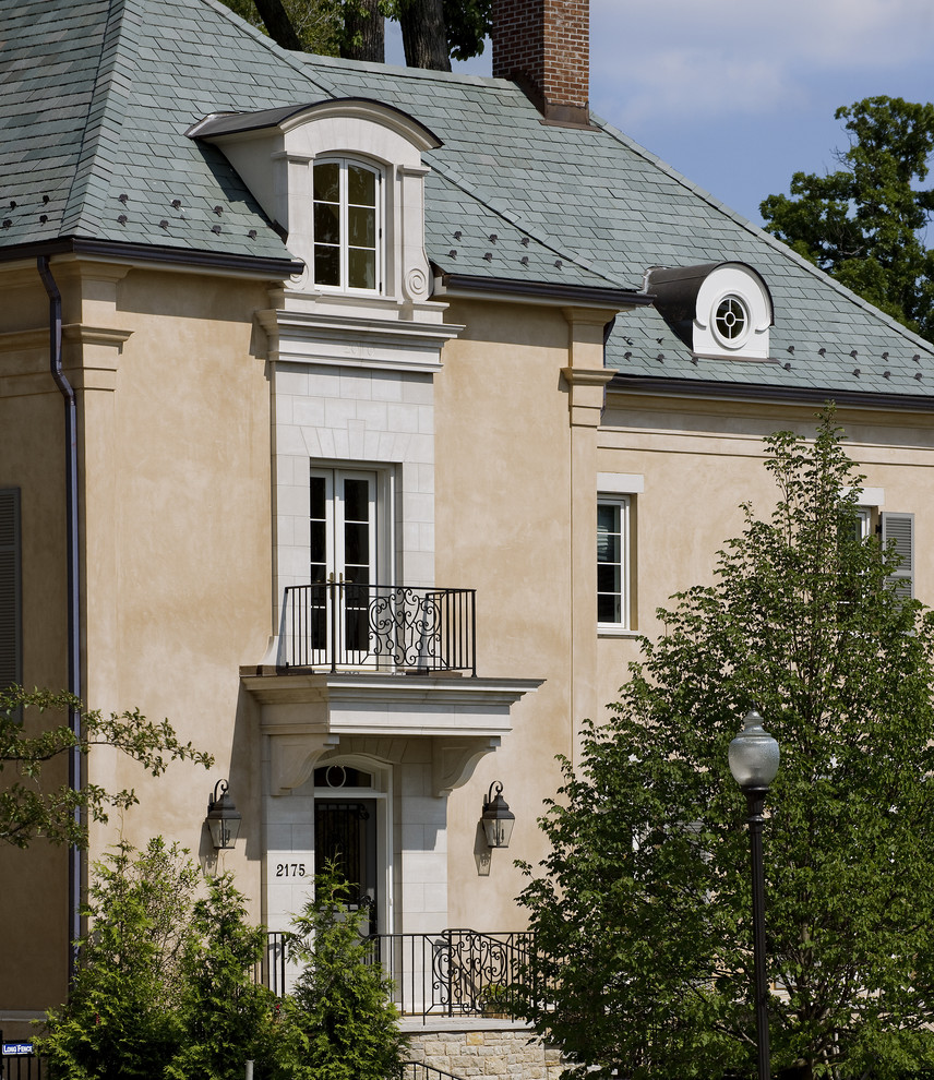 This is an example of a mediterranean three-storey stucco beige exterior in DC Metro.