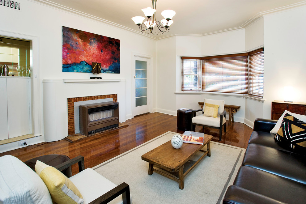 Design ideas for a large contemporary enclosed living room in Melbourne with white walls, dark hardwood floors, a brick fireplace surround and a home bar.