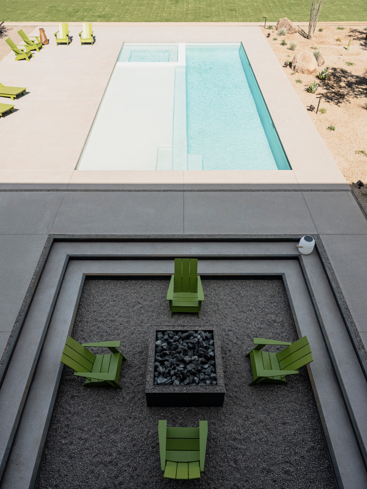 Esempio di una piscina minimalista rettangolare con graniglia di granito