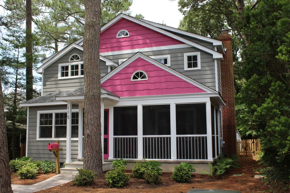 Inspiration for a mid-sized transitional two-storey pink house exterior in Other with mixed siding, a gable roof and a shingle roof.