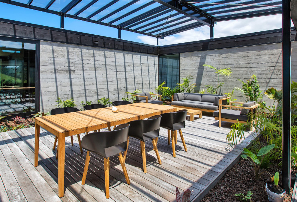 Inspiration for a mid-sized modern courtyard and ground level deck in Other with a pergola.