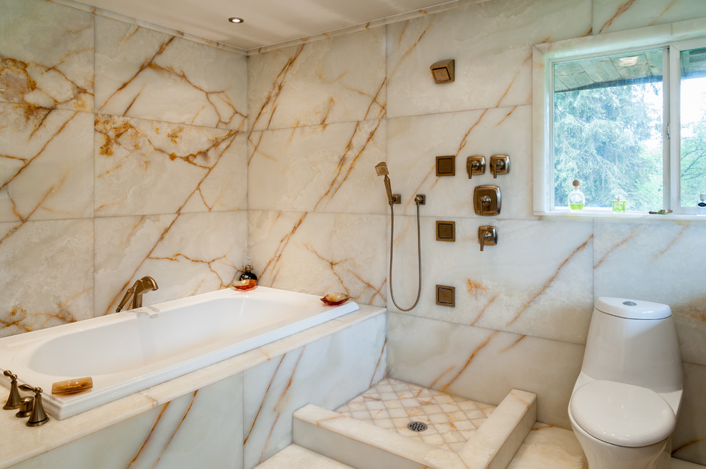 Inspiration for a contemporary bathroom in Seattle with a drop-in tub, an open shower, a one-piece toilet, beige tile, stone tile, beige walls and an open shower.