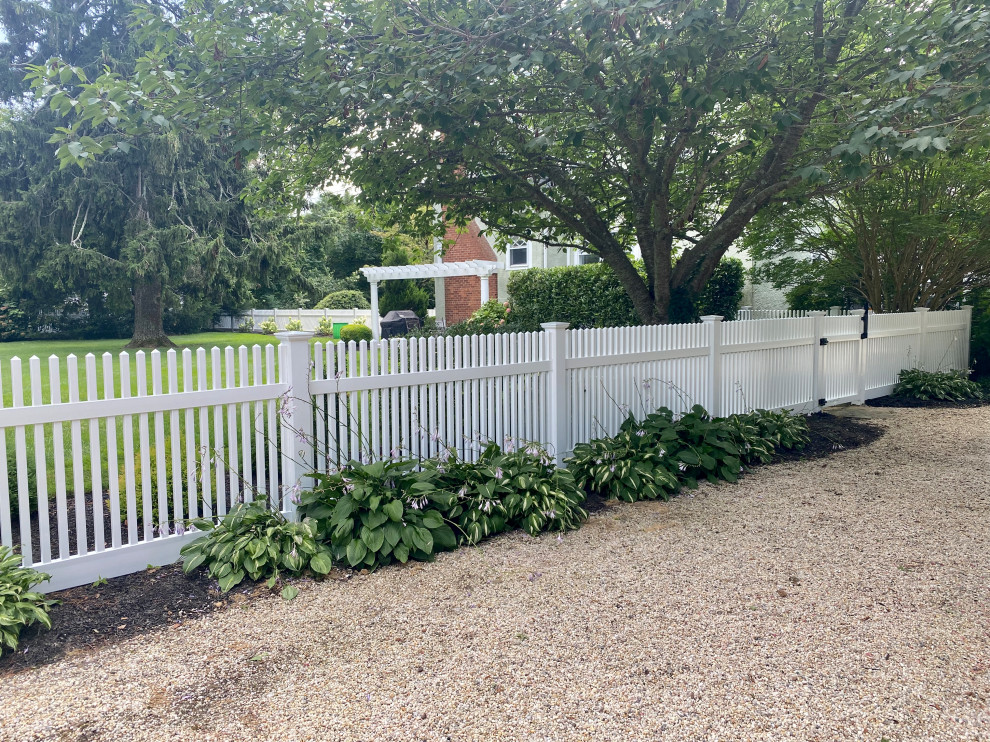 Traditional garden in New York with with a gate and a vinyl fence.