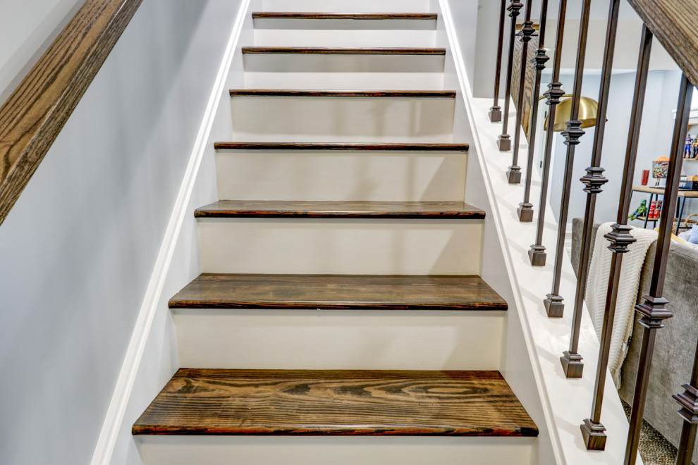 Large transitional walk-out vinyl floor and brown floor basement photo with gray walls
