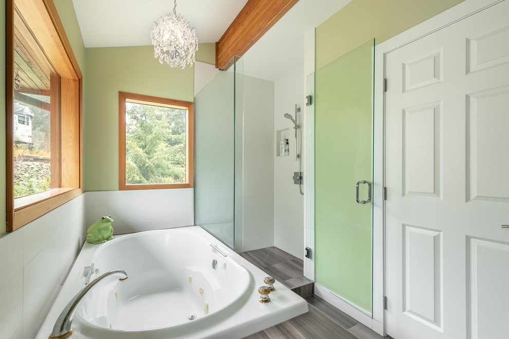 Inspiration for a mid-sized contemporary master bathroom with a drop-in tub, a corner shower, a one-piece toilet, green walls, an undermount sink and a hinged shower door.