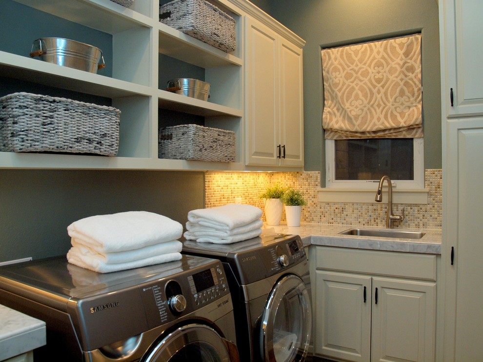 Inspiration for a mid-sized transitional l-shaped dedicated laundry room remodel in Austin with an undermount sink, raised-panel cabinets, white cabinets, marble countertops, green walls and a side-by-side washer/dryer