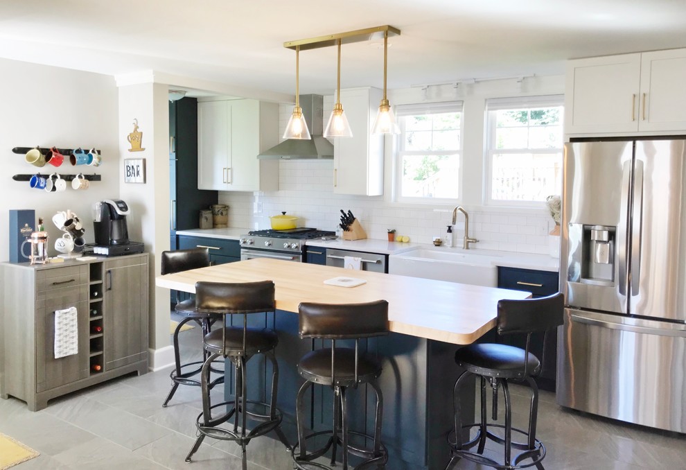 Inspiration for a transitional gray floor kitchen remodel with a farmhouse sink, quartz countertops and stainless steel appliances