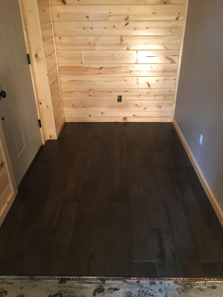 Mudroom - mid-sized rustic porcelain tile mudroom idea with brown walls