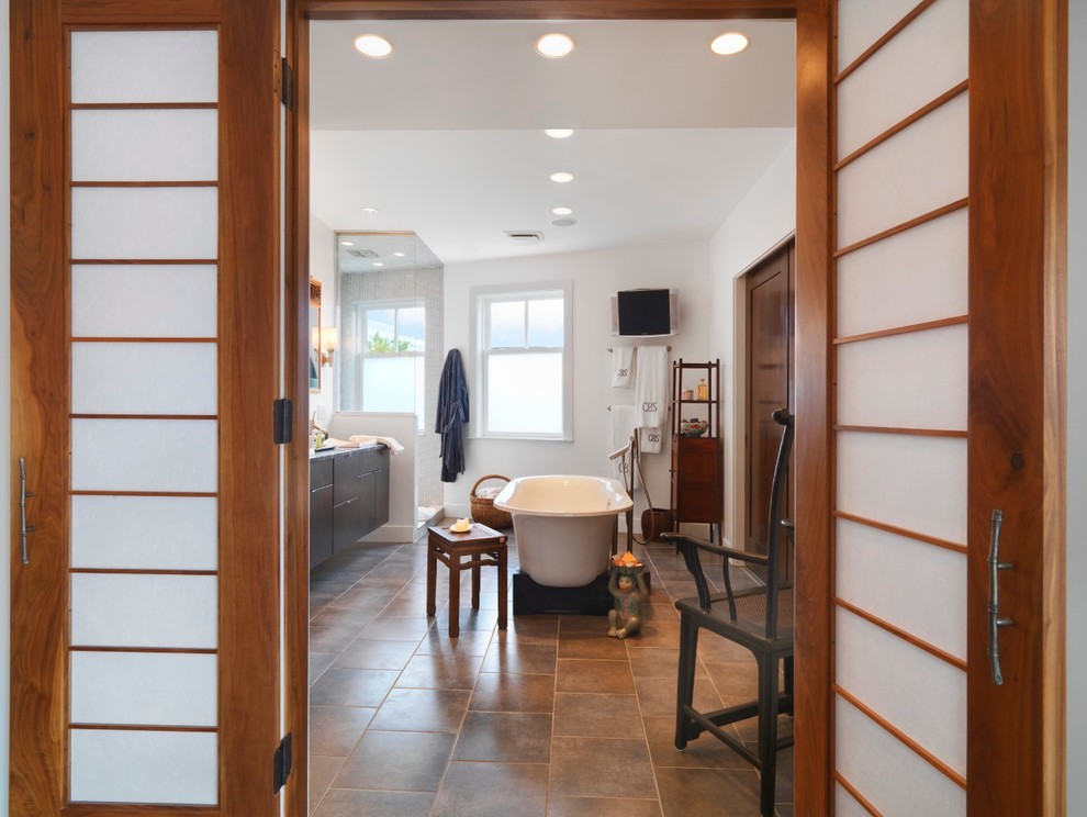 This is an example of a large asian master bathroom in Other with flat-panel cabinets, dark wood cabinets, granite benchtops, a freestanding tub, a corner shower, ceramic tile, white walls, ceramic floors, a drop-in sink, brown floor and a hinged shower door.
