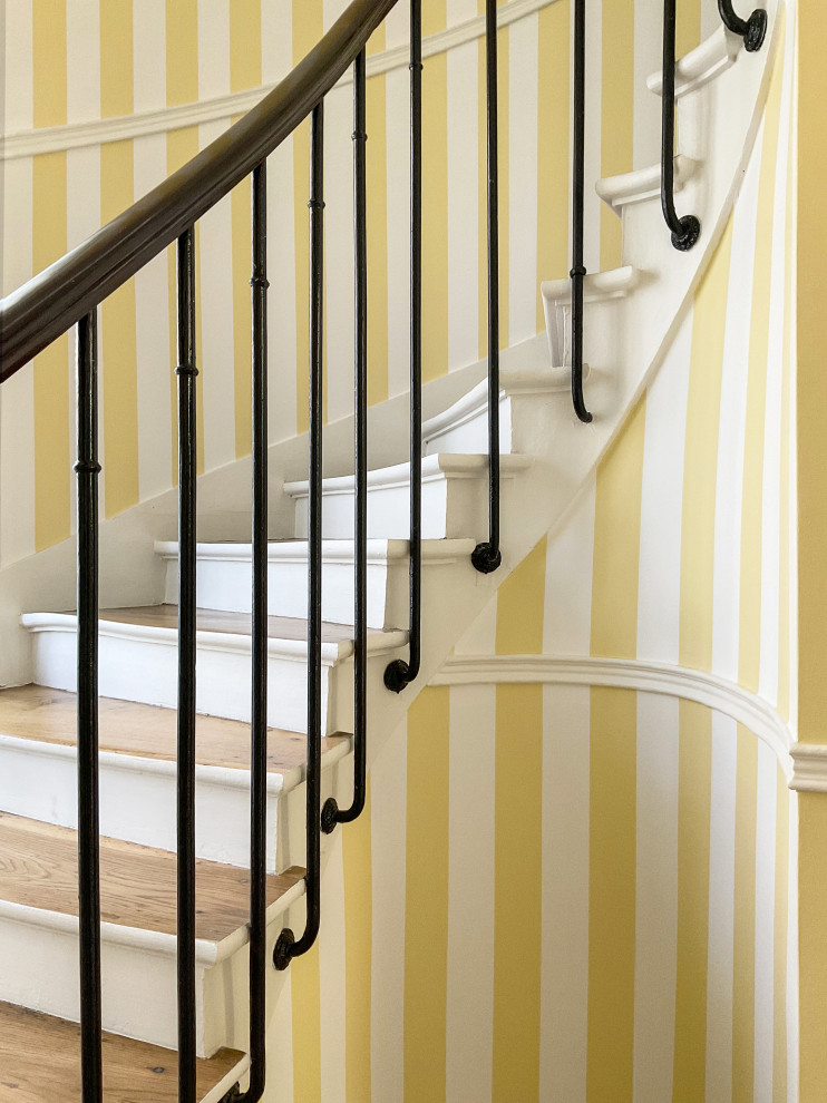 Inspiration for a staircase in Paris with wallpaper.
