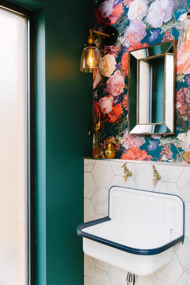 Inspiration for a small transitional powder room in London with multi-coloured walls, a wall-mount sink and a one-piece toilet.
