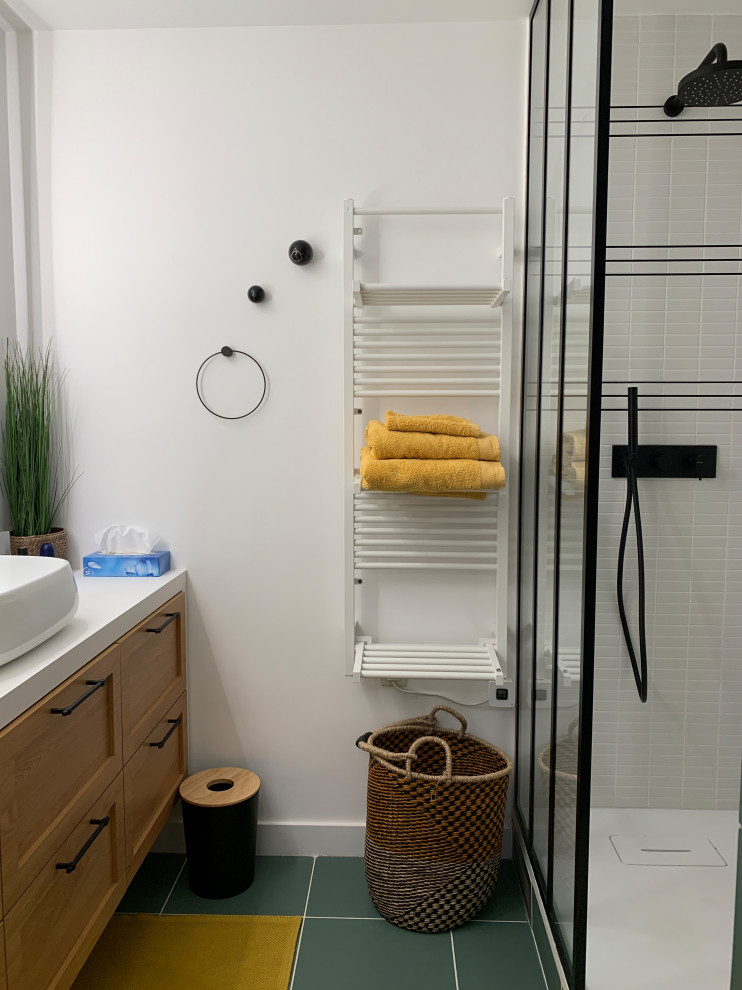 Photo of a small contemporary 3/4 bathroom in Paris with light wood cabinets, an open shower, a two-piece toilet, white tile, ceramic tile, white walls, ceramic floors, a drop-in sink, laminate benchtops, green floor, an open shower and white benchtops.