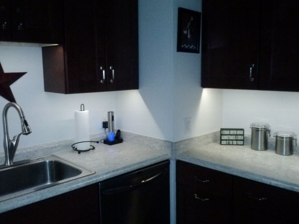 Small transitional l-shaped vinyl floor enclosed kitchen photo in Richmond with a drop-in sink, shaker cabinets, dark wood cabinets, granite countertops, white backsplash and stainless steel appliances