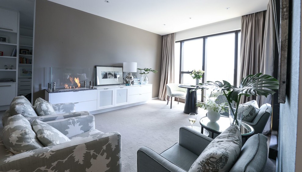 Transitional living room in Melbourne with grey walls, carpet, a ribbon fireplace and a stone fireplace surround.