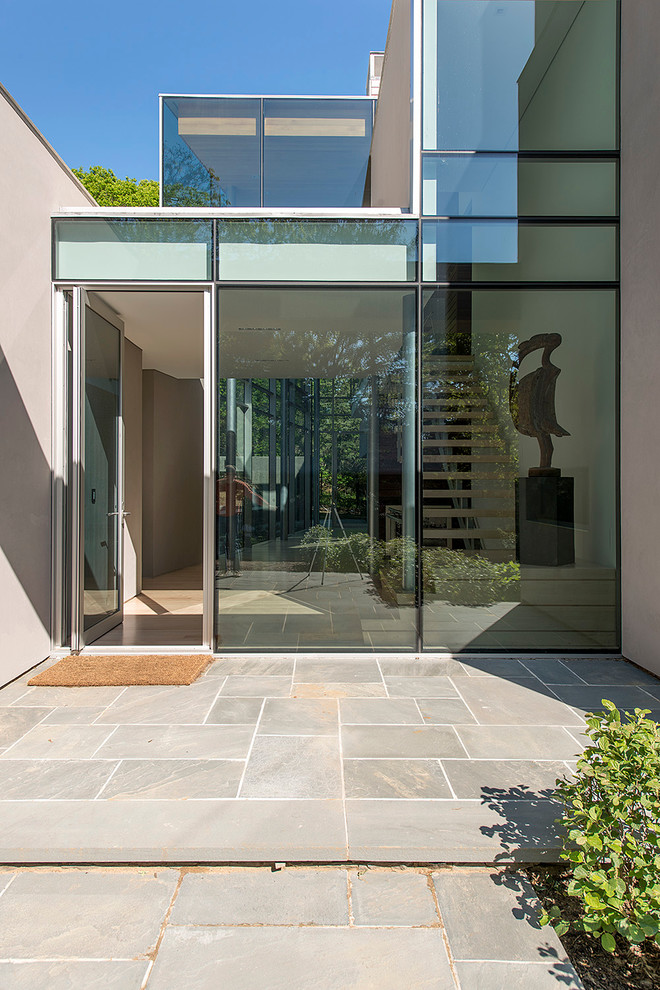 Photo of a contemporary front door in New York with a single front door and a glass front door.