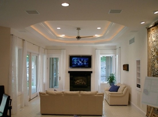 Inspiration for a mid-sized enclosed ceramic tile family room remodel in Detroit with white walls, a standard fireplace, a metal fireplace and a wall-mounted tv
