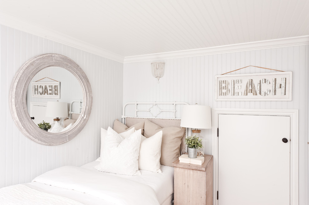 Photo of a beach style guest bedroom in Orange County with white walls.