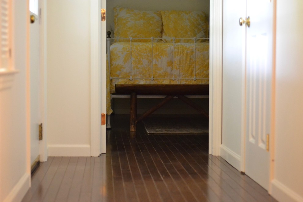 Example of a dark wood floor and brown floor basement design with white walls