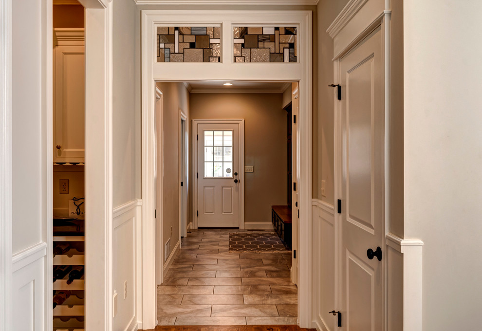 Photo of an arts and crafts hallway in Other with grey walls and medium hardwood floors.
