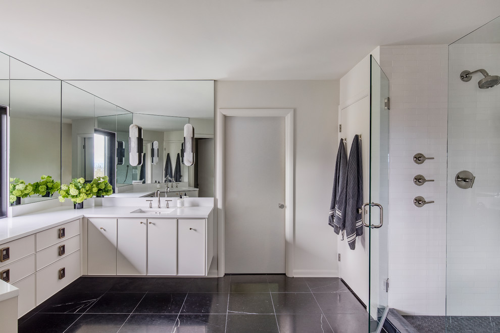 Photo of a mid-sized contemporary master bathroom in Portland with flat-panel cabinets, white cabinets, an open shower, white tile, white walls, an undermount sink, engineered quartz benchtops, black floor, a hinged shower door and white benchtops.