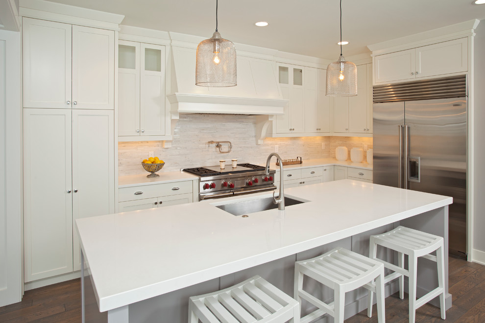 Design ideas for a beach style l-shaped kitchen in Minneapolis with an undermount sink, shaker cabinets, white cabinets and stainless steel appliances.