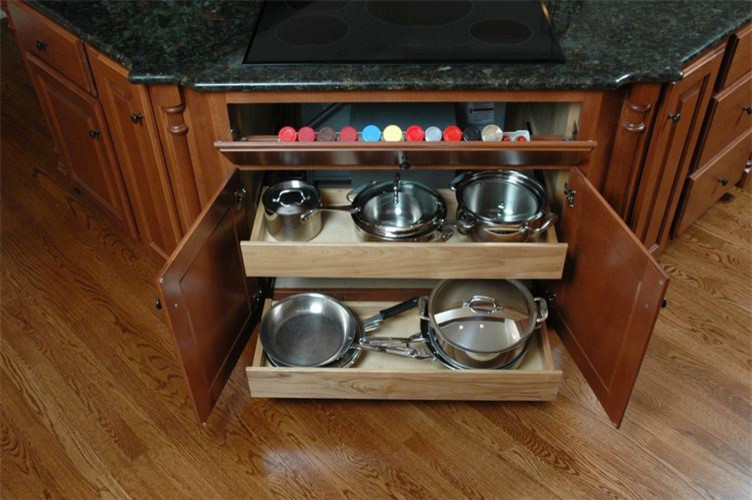 Example of a mid-sized light wood floor kitchen design with medium tone wood cabinets, granite countertops and an island