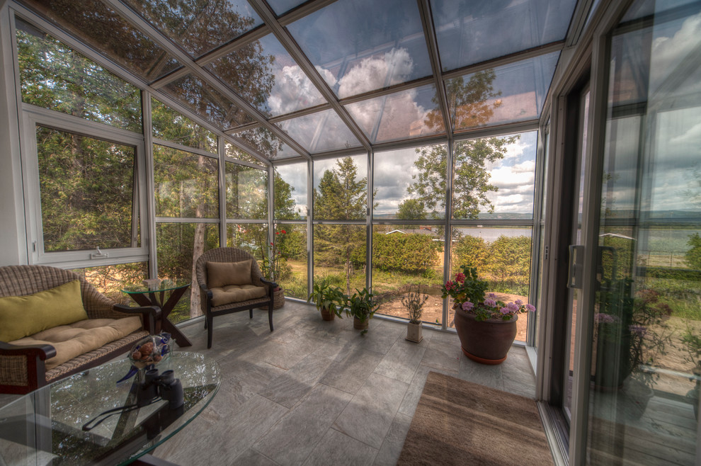 Photo of a mid-sized eclectic sunroom in Ottawa with vinyl floors, no fireplace, a glass ceiling and grey floor.