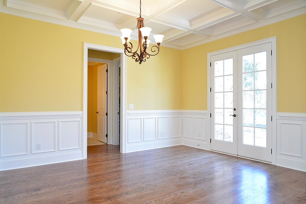 Large country foyer in Raleigh with yellow walls, medium hardwood floors, a double front door and a white front door.