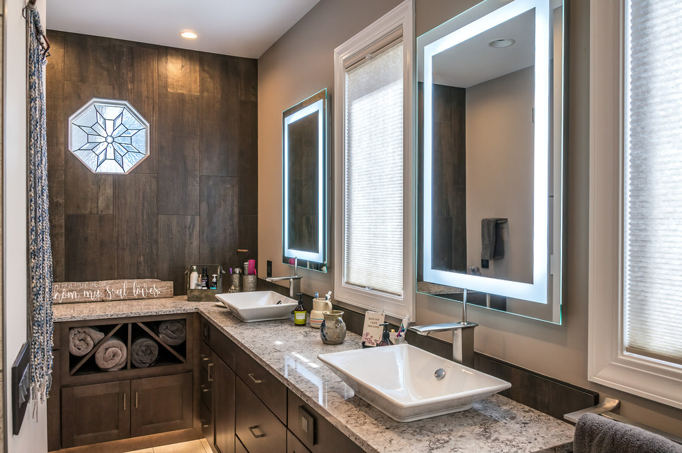This is an example of a mid-sized contemporary master bathroom in Other with flat-panel cabinets, dark wood cabinets, an alcove shower, beige tile, ceramic tile, beige walls, ceramic floors, a vessel sink, beige floor, a hinged shower door, granite benchtops and brown benchtops.