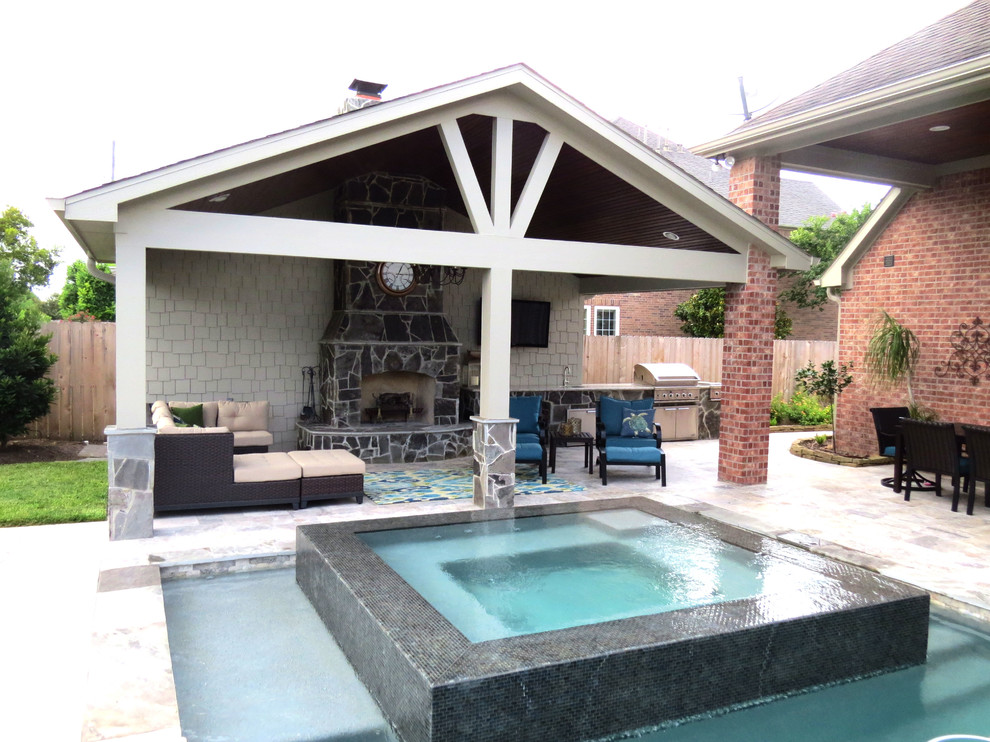 This is an example of a large contemporary backyard patio in Houston with an outdoor kitchen, stamped concrete and a gazebo/cabana.