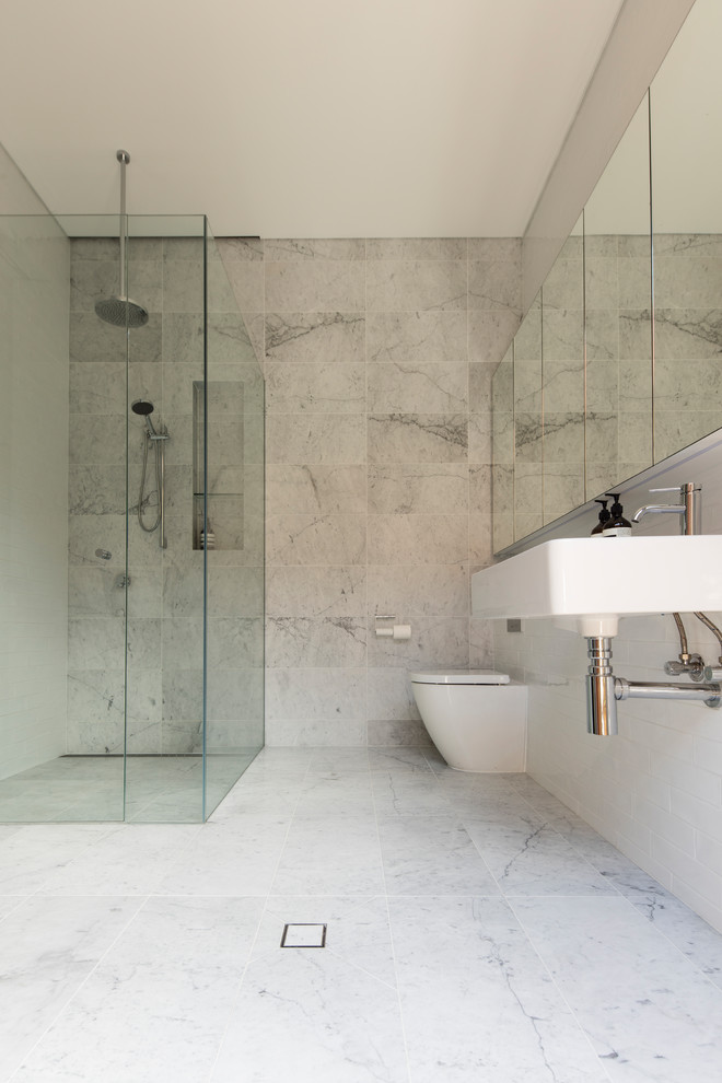 Contemporary bathroom in Sydney with glass-front cabinets, white tile and white floor.