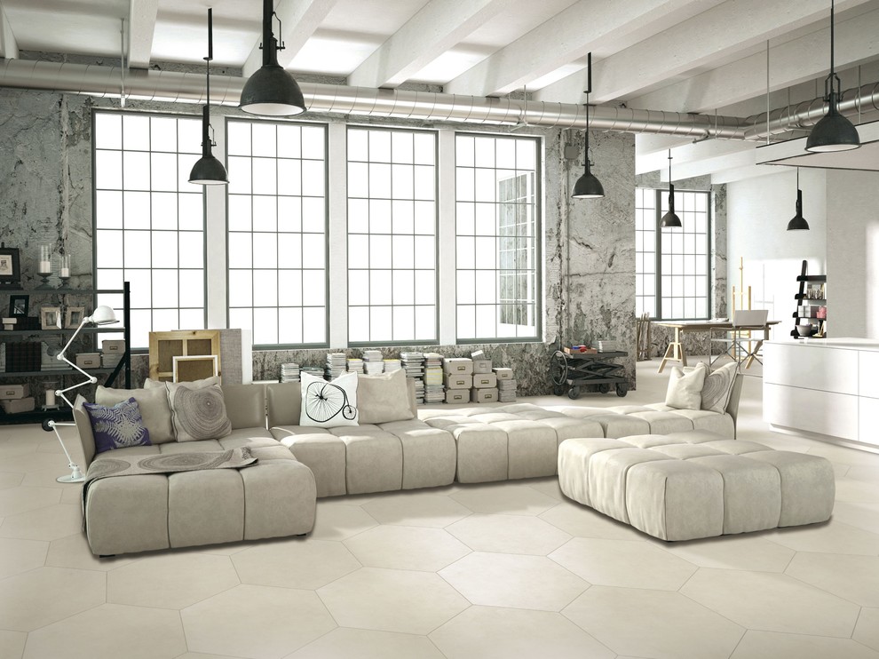 This is an example of an expansive industrial open concept living room in Manchester with grey walls and ceramic floors.
