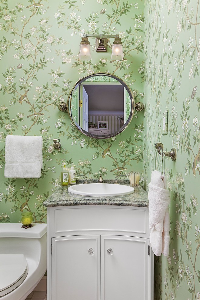 Inspiration for a timeless powder room remodel in Detroit with a one-piece toilet, green walls and a console sink