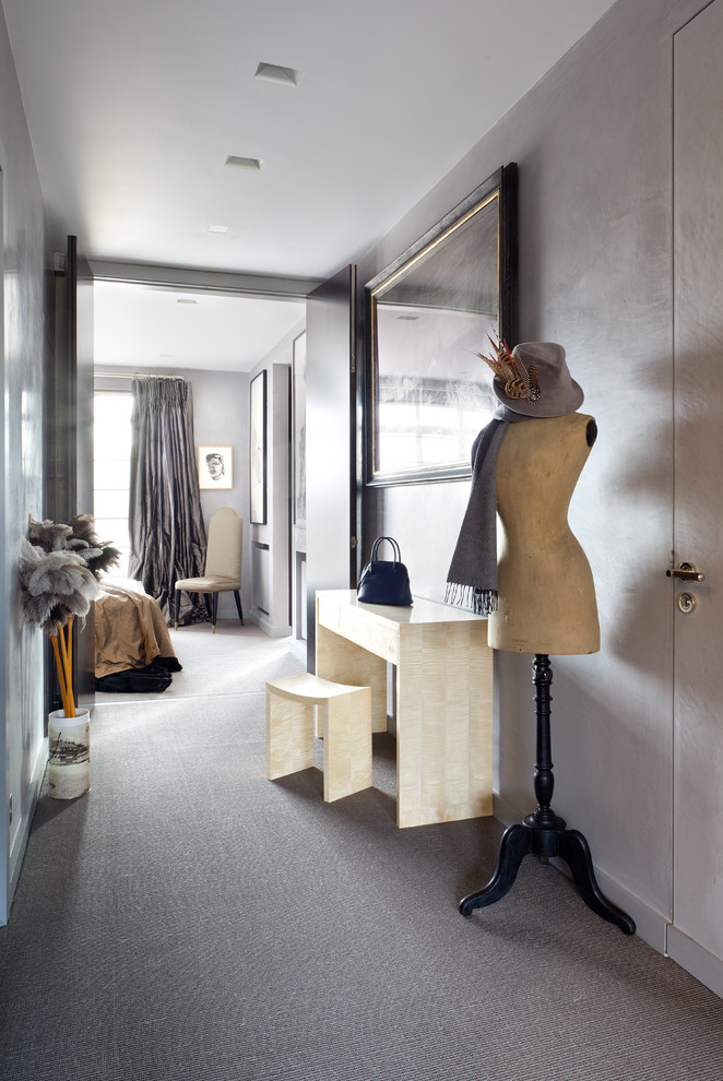 This is an example of a contemporary hallway in London with grey walls and carpet.