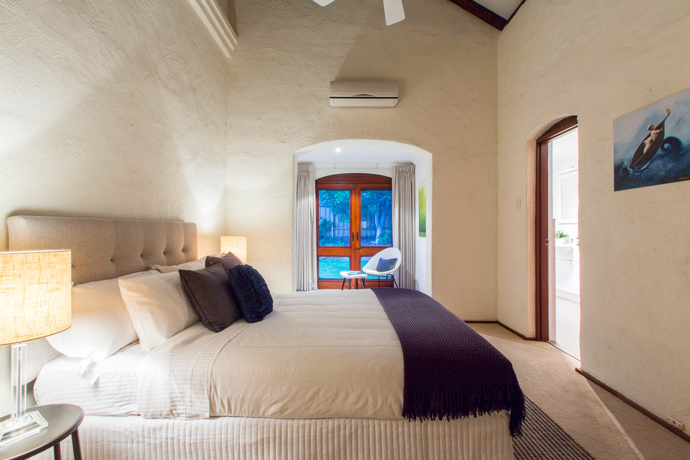 This is an example of a traditional bedroom in Perth with beige walls and carpet.