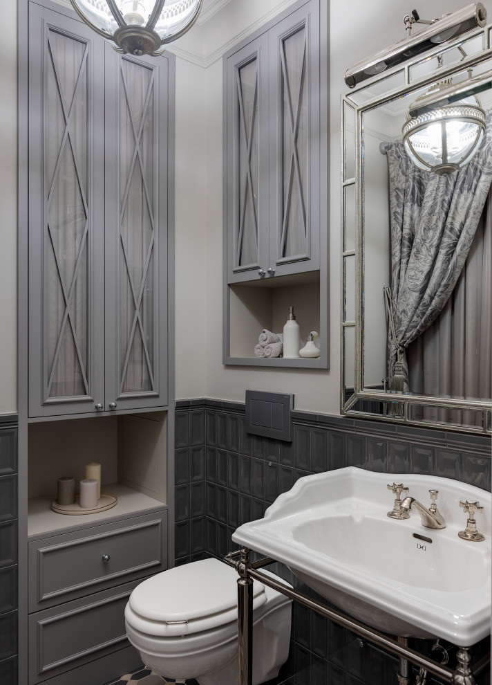 Photo of a powder room in Moscow with gray tile, grey walls and a console sink.