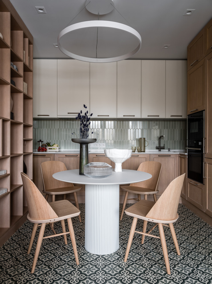 Aménagement d'une petite salle à manger ouverte sur la cuisine contemporaine avec un mur blanc, un sol en carrelage de porcelaine et un sol vert.