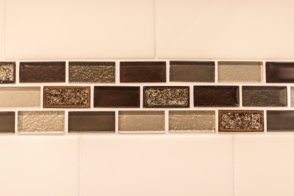 Example of a mid-sized transitional u-shaped vinyl floor and brown floor kitchen design with an undermount sink, recessed-panel cabinets, brown cabinets, quartz countertops, multicolored backsplash, porcelain backsplash, stainless steel appliances, a peninsula and multicolored countertops