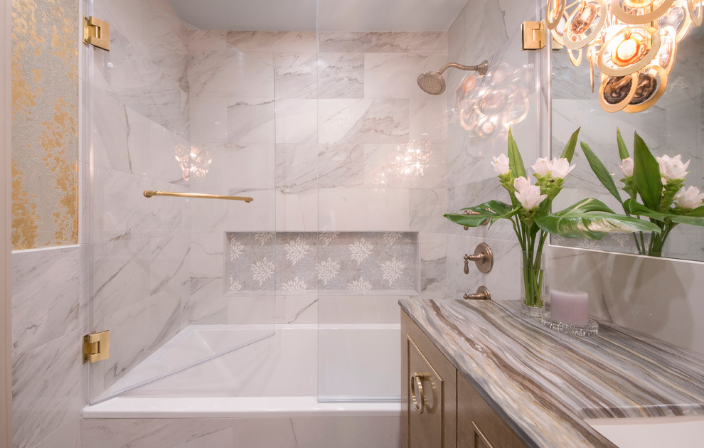 Mid-sized traditional master bathroom in New York with furniture-like cabinets, beige cabinets, a corner tub, a shower/bathtub combo, a two-piece toilet, gray tile, porcelain tile, multi-coloured walls, porcelain floors, an undermount sink, grey floor, a hinged shower door and marble benchtops.
