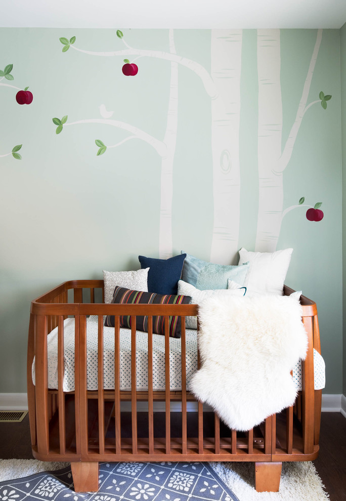 Mid-sized trendy gender-neutral dark wood floor nursery photo in Toronto with blue walls