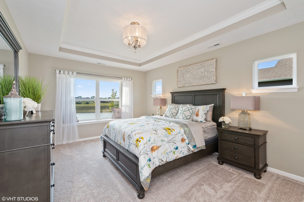 Inspiration for a large transitional master bedroom in Indianapolis with beige walls, carpet, beige floor and recessed.