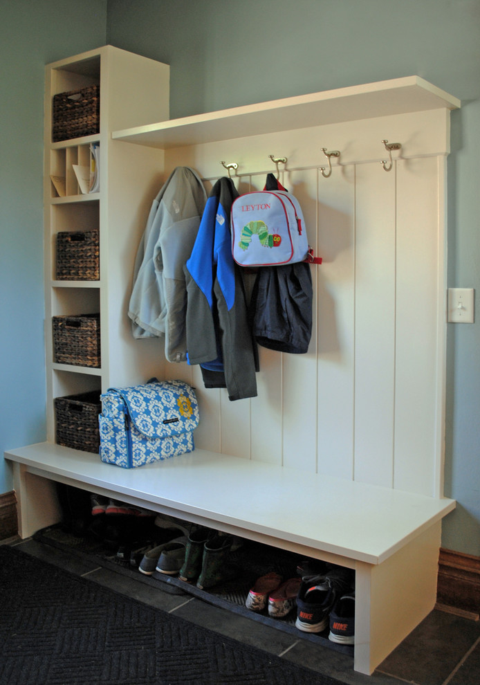 Small transitional mudroom in Other with blue walls and ceramic floors.