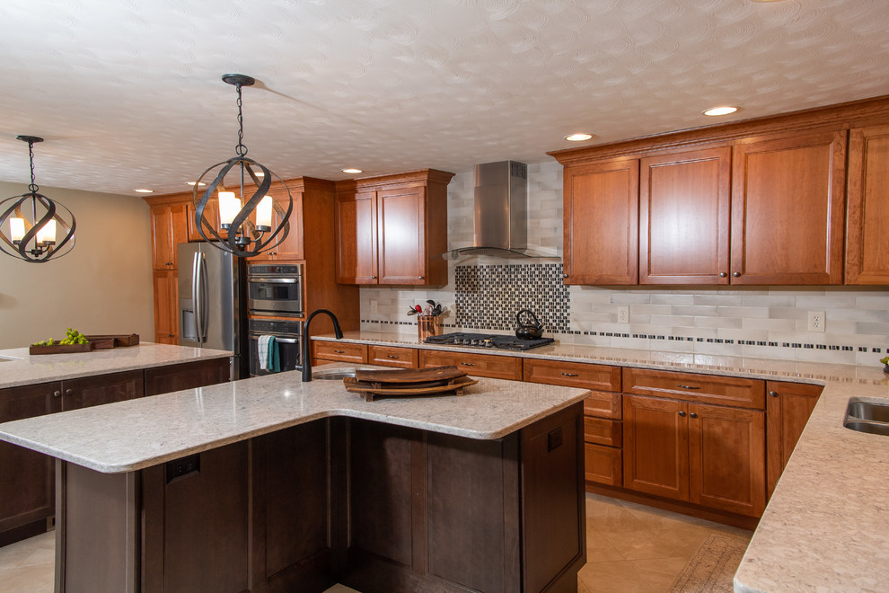 Huge transitional l-shaped porcelain tile and white floor eat-in kitchen photo with an undermount sink, flat-panel cabinets, medium tone wood cabinets, quartz countertops, white backsplash, ceramic backsplash, stainless steel appliances, two islands and white countertops