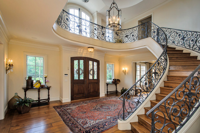 This is an example of an expansive traditional wood spiral staircase in San Francisco with wood risers.