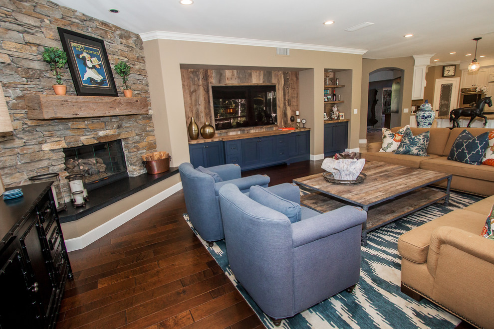 Mid-sized traditional open concept living room in Orange County with beige walls, dark hardwood floors, a standard fireplace, a stone fireplace surround and a wall-mounted tv.