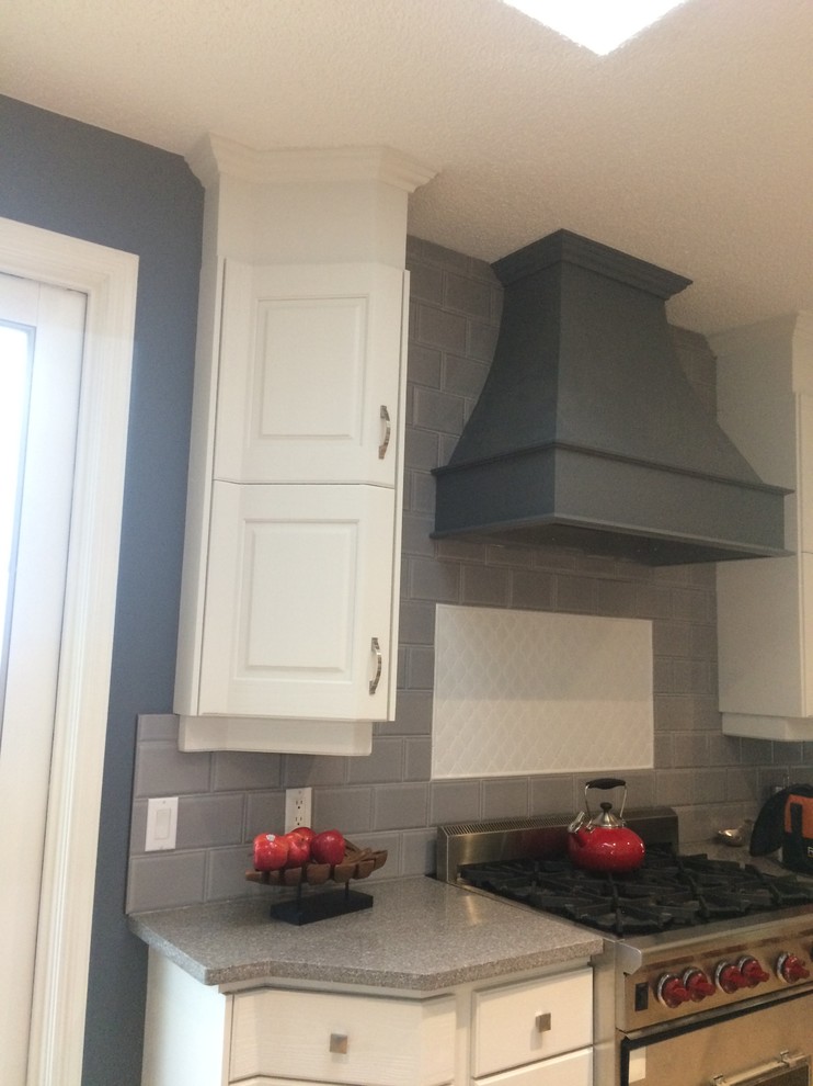 Example of a transitional kitchen design in Calgary